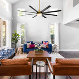 Black and gold AeroSpan Lux large ceiling fan with light suspended from a high ceiling in a spacious living room