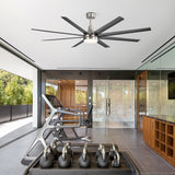 Black 8-blade ceiling fan with integrated LED light and silver accents installed in a modern home gym