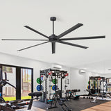 Ceiling fan in a gym setting with exercise equipment and large windows.