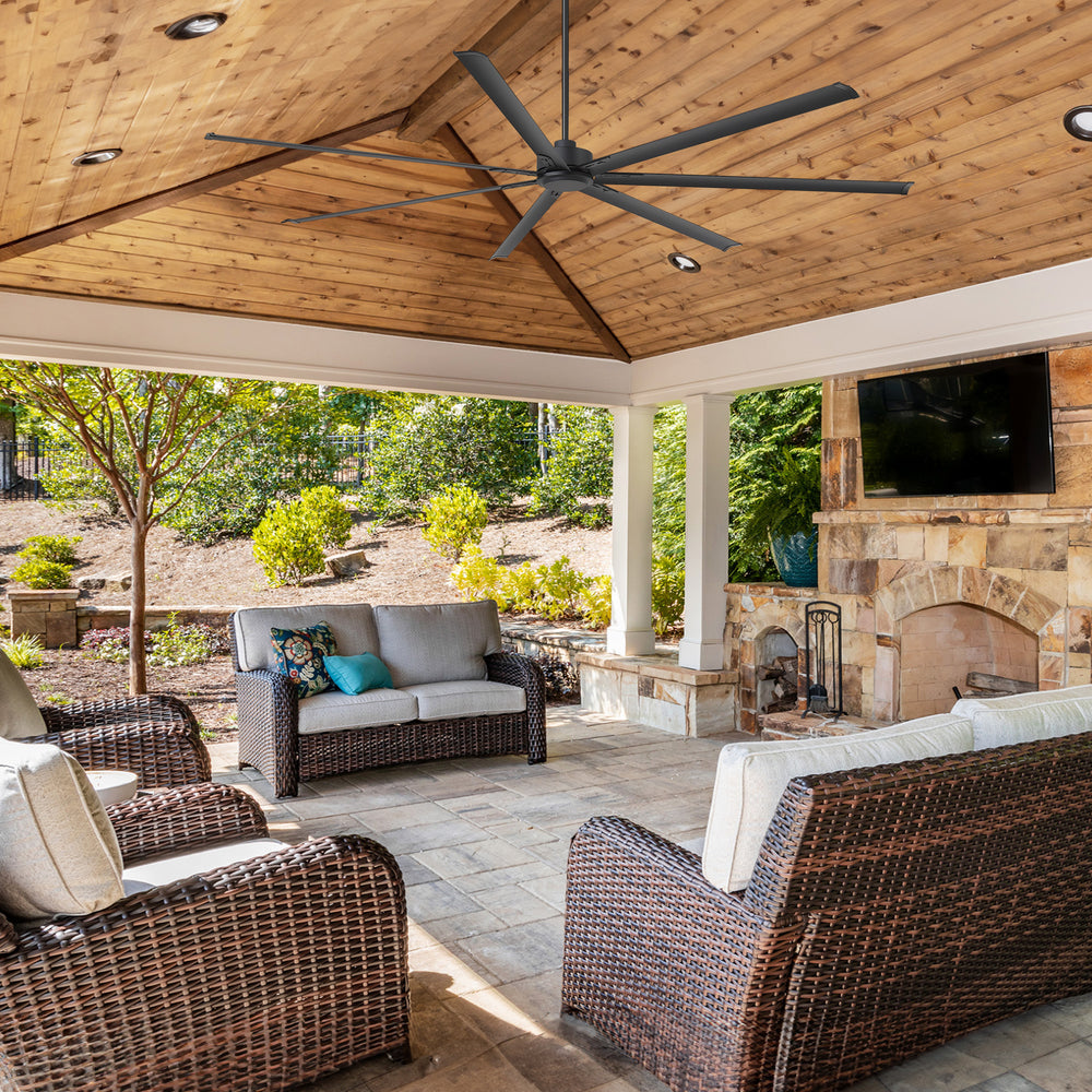 AeroSpan XL large black ceiling fan installed on a covered outdoor patio for wide-area air circulation