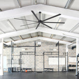 AirForge 120-inch HVLS ceiling fan with 7 black blades installed in a spacious gym.
