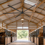 AeroVault HVLS industrial ceiling fan installed in a horse stable for improved air circulation and ventilation
