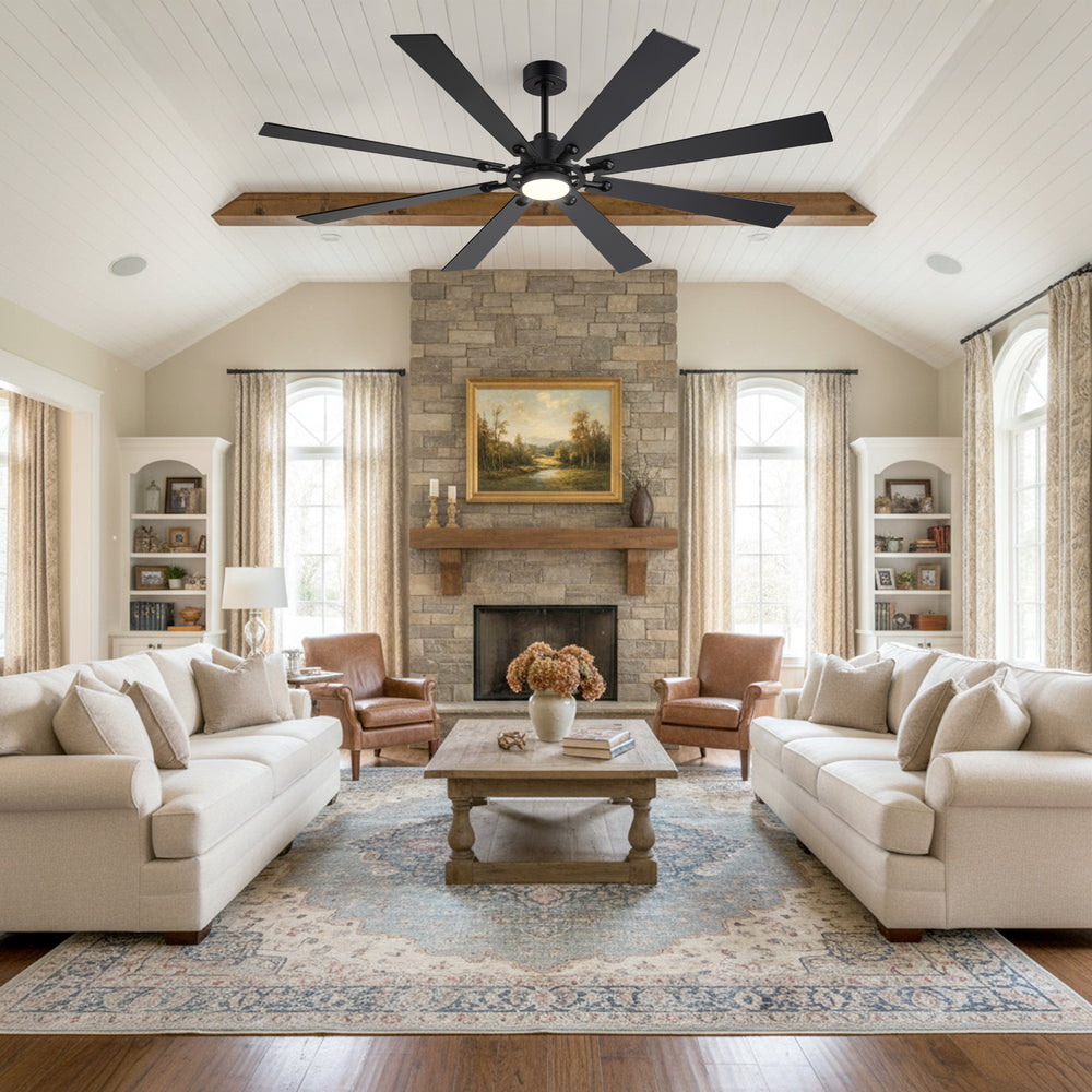 Living room with stone fireplace under Jovora 72-inch large black 8-blade ceiling fan glowing light