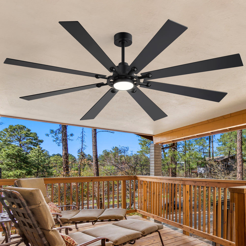 Jovora 72-inch large black 8-blade ceiling fan with light on a covered patio featuring wood railing and outdoor seating