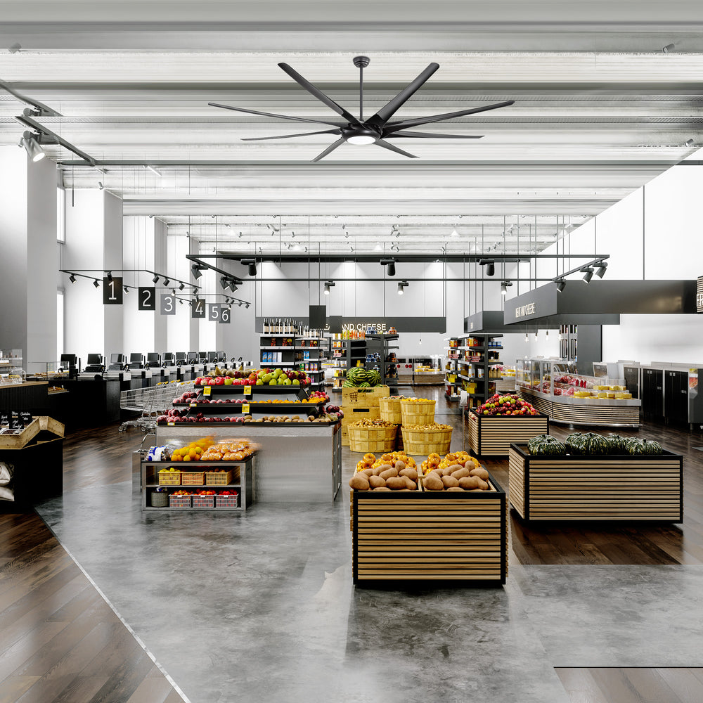 Large black ceiling fan with integrated LED light installed in a modern supermarket