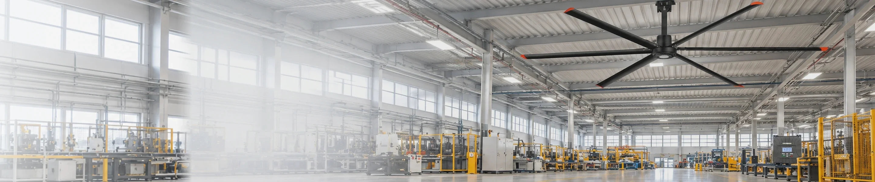 Large industrial HVLS ceiling fan installed beneath a steel-beam warehouse ceiling