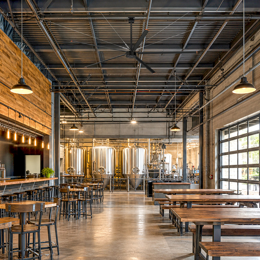 AeroVault 12 FT HVLS industrial ceiling fan with five aluminum blades installed in a spacious brewery and taproom.