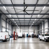 AeroVault 12 FT HVLS industrial ceiling fan with five aluminum blades installed in a large automotive service garage.