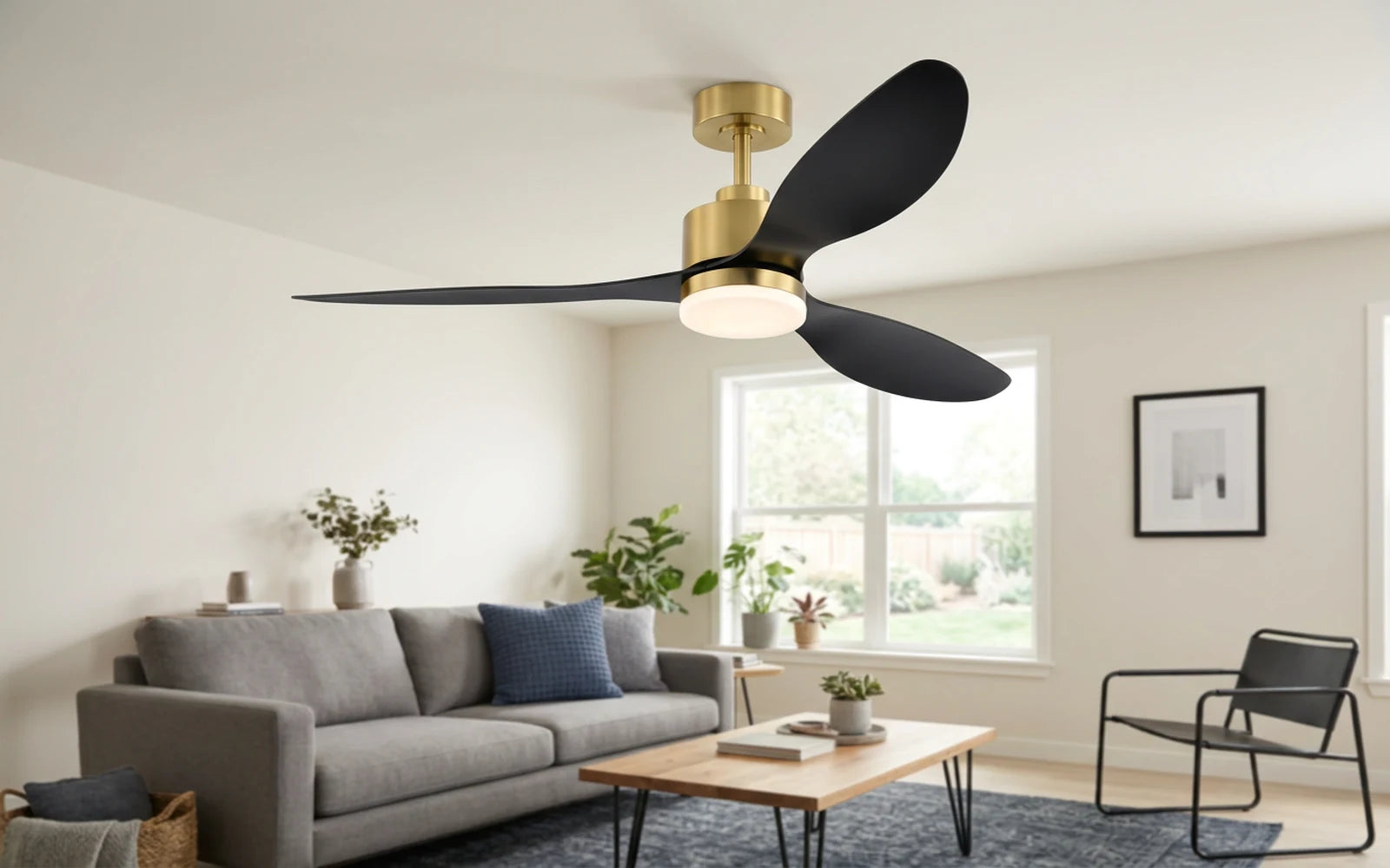Three blade gold ceiling fan with light and remote control installed in a modern living room