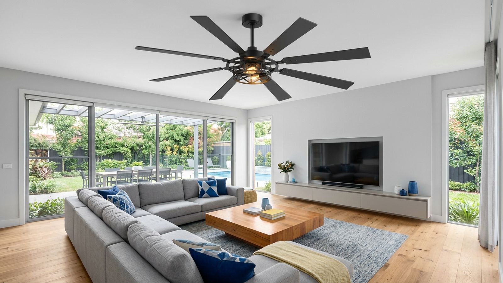 Large multi-blade ceiling fan installed above a modern living room