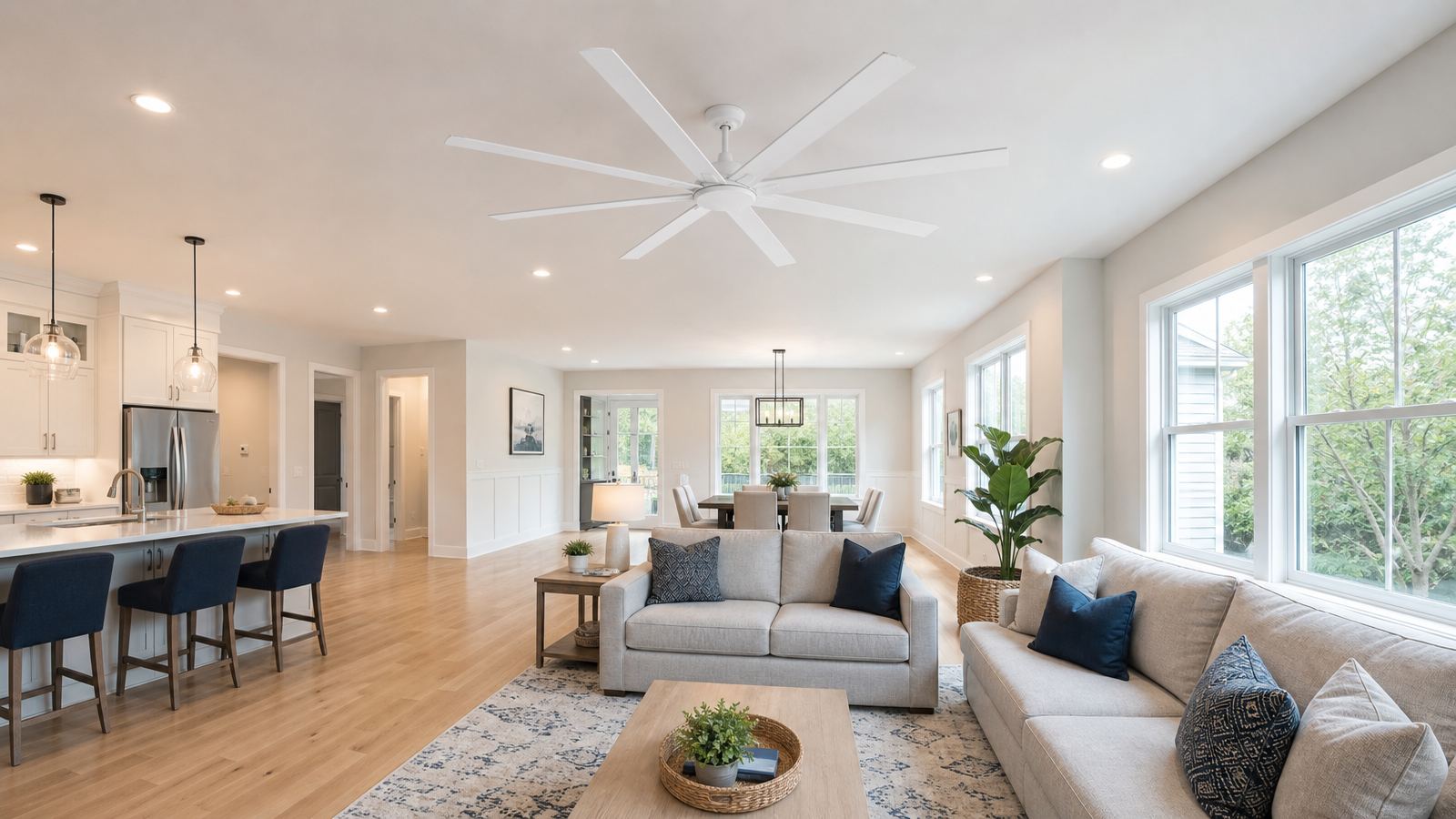 Large white ceiling fan without a light in a room with recessed lighting